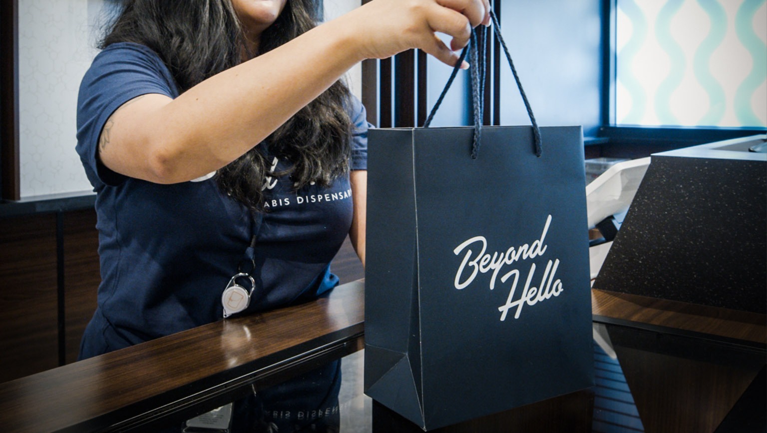 Customer receiving a Beyond Hello shopping bag